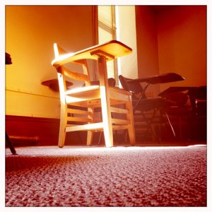 Sunlit chair in old classroom